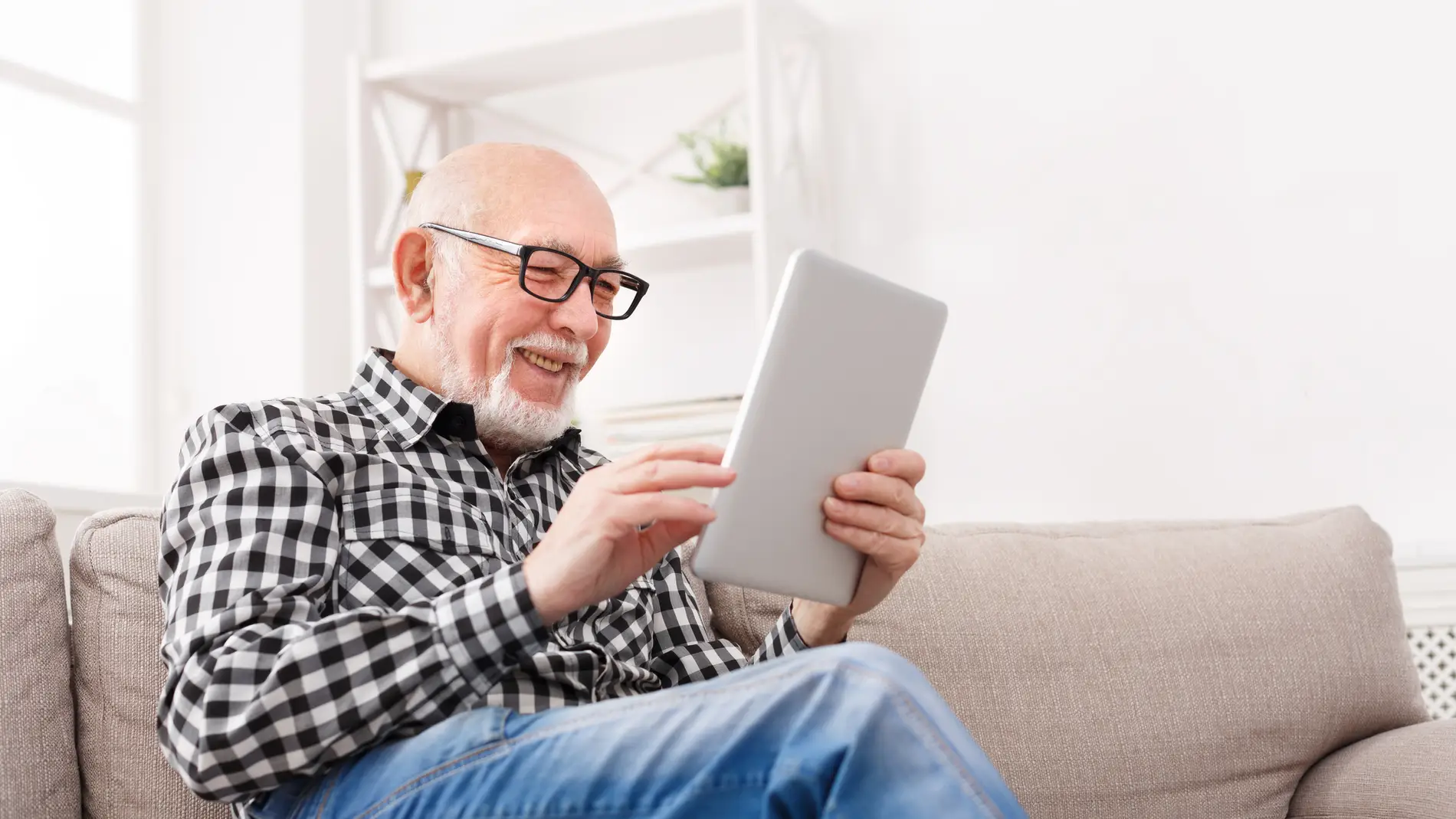 Hombre mayor navegando por Internet con una tablet