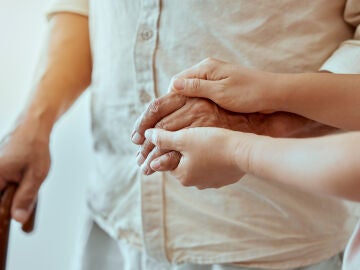 Una mujer ayudando a un hombre a caminar