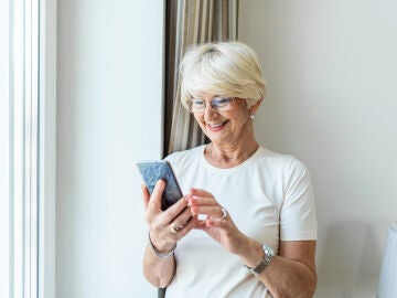 Mujer mayor usando un tel&eacute;fono m&oacute;vil