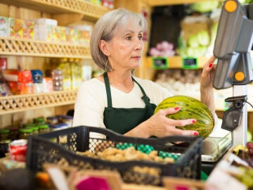 Mujer mayor atendiendo en una fruter&iacute;a