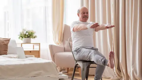 Hombre mayor haciendo ejercicios en casa Hombre mayor haciendo ejercicios en casa