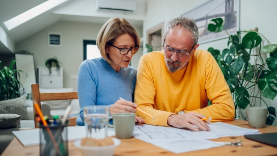 Pareja calculando la pensión de jubilación Pareja calculando la pensión de jubilación