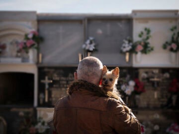 Hombre con un perro en un cementerio