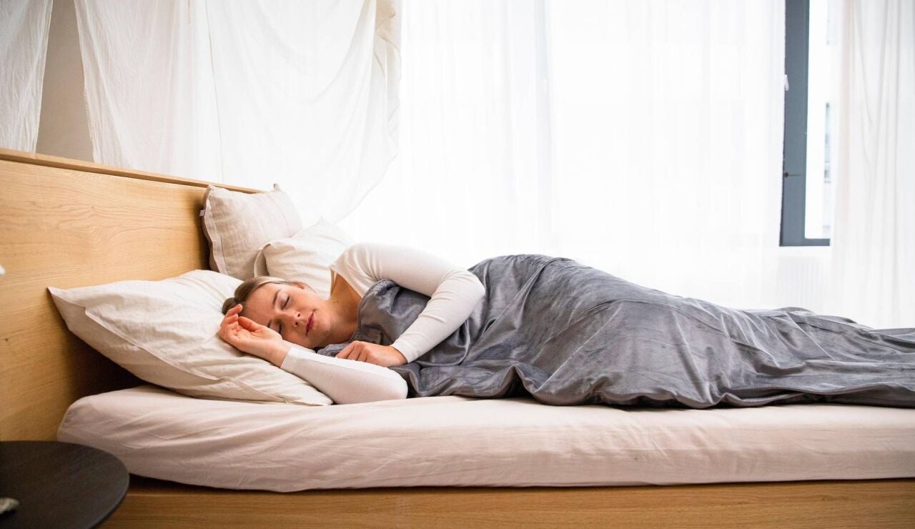 Mujer descansando sobre una cama