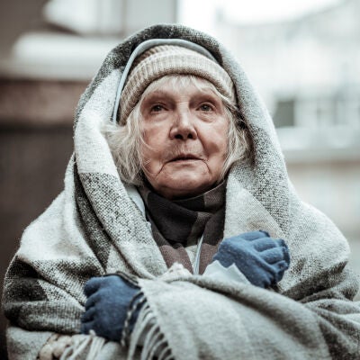 Mujer mayor arropada con una manta