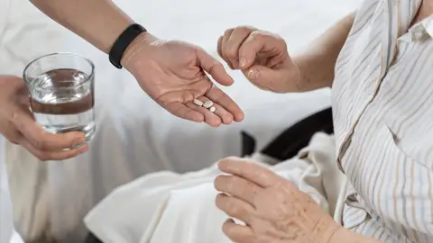 Administrando medicación a una persona mayor Administrando medicación a una persona mayor