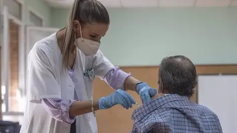 Enfermera poniendo una vacuna Enfermera poniendo una vacuna