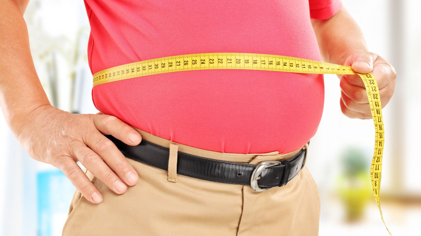 Hombre mayor midi&eacute;ndose la barriga