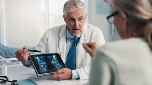 M&eacute;dico experto hablando con paciente de sus huesos