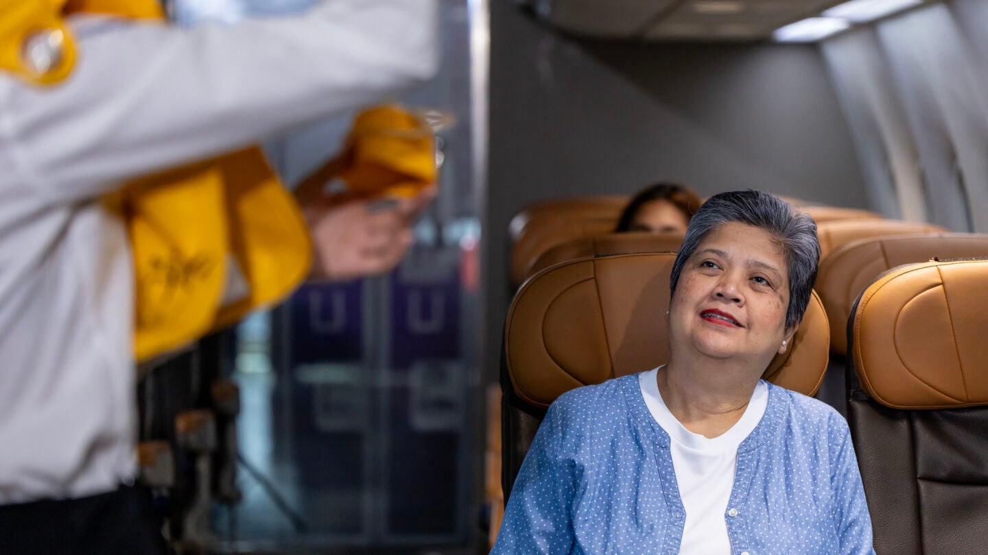 Mujer mayor en la cabina de un avi&oacute;n